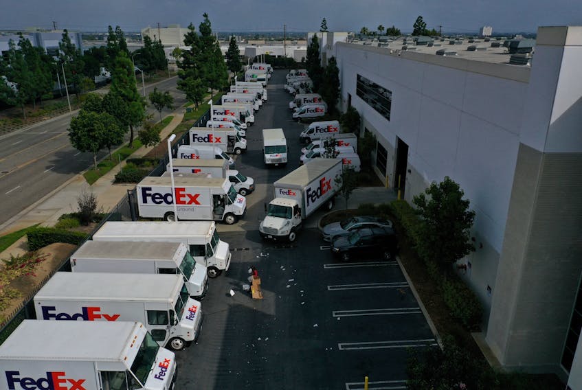 A worker clears debris so delivery vehicles can exit a FedEx Ground distribution center in this aerial photograph taken over Carson, California, U.S., September 16, 2022. 