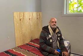Steven Blake and his son were placed in the basement unit of 64 Larkhall Street. The walls are mostly made of plywood, as pictured in this bedroom. (Jenna Head/ Saltwire)