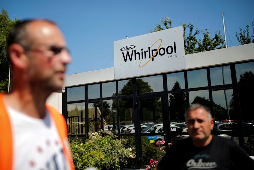 Employees stand at the Whirlpool company plant in the northern city of Amiens, France, June 14, 2017.