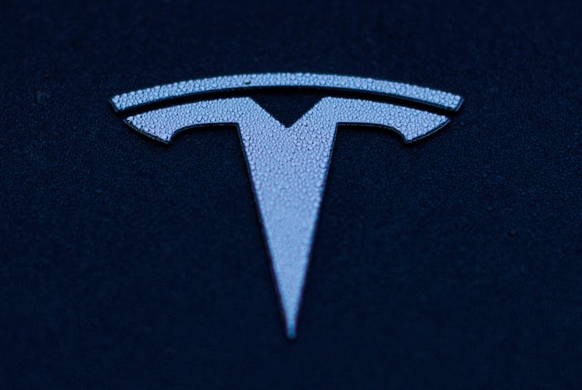 A Tesla logo is shown on a Model 3 vehicle in Encinitas, California, U.S.,October 20, 2023.