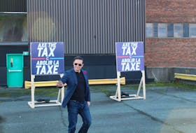 Pierre Poilievre makes a his entrance to a press conference held on October 27 in St. John's, flanked by 'Axe the Tax' signs. - Cameron Kilfoy/The Telegram.