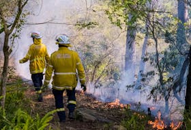 By Lewis Jackson SYDNEY (Reuters) - A bushfire in Australia's Victoria state more than trebled overnight and authorities urged residents in a remote part of Tasmania state to evacuate as a spring