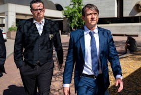 Cameron Ortis, right, a former RCMP intelligence director accused of disclosing classified information, leaves an Ottawa courthouse on Tuesday, Oct. 3, 2023.