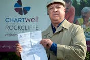 Chris Monk displays a recent bill from Chartwell Rockcliffe Retirement Residence.