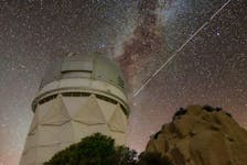 Trails in the night sky left by BlueWalker 3 are juxtaposed against the Nicholas U. Mayall 4-metre Telescope at Kitt Peak National Observatory in Arizona.
