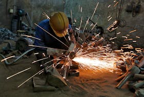 BENGALURU (Reuters) - India's factory activity expanded at the slowest pace in five months in September but remained solid, with strong demand driving business confidence to its highest level this