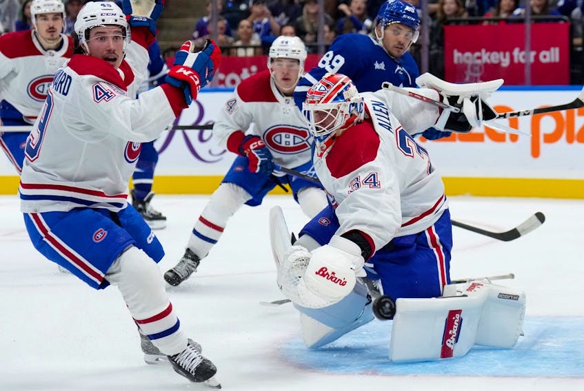 Montreal Canadiens' Rafael Harvey-Pinard (left) reacts as Canadiens goaltender Jake Allen makes a save during the second period in pre-season action against the Maple Leafs in Toronto, Monday, Oct. 2, 2023. 