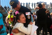 A youngster embraces her father (UNIDENTIFIED) at the homecoing ceremony for HMCS Monreal from it's 6 month deployment in the Indo-Pacific...at HMCS Dcckyard in Halifax Tuesday October 3, 2023. Amongst it's duties, took part in Operation Savanne, where they supported Global Affairs with assessing issues with the devoving situarion in Sudan.

TIM KROCHAK PHOTO