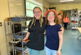 Jordan Luddington (left) and Audrey Taylor are two Northumberland Regional High School students who are part of Karma Closet. They volunteer their lunch hour to help clean up and keep the flow of students organized. Sarah Jordan