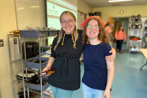 Jordan Luddington (left) and Audrey Taylor are two Northumberland Regional High School students who are part of Karma Closet. They volunteer their lunch hour to help clean up and keep the flow of students organized. Sarah Jordan