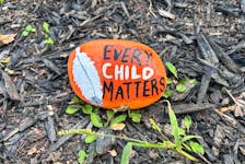The garden beds along the Pictou waterfront are decorated with painted rocks, with messages such as "be kind" and "love" on them, along with bright orange stones painted with "every child matters" on them. Sarah Jordan