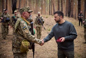 KYIV (Reuters) - Ukrainian President Volodymyr Zelenskiy visited troops fighting in the northeast on Tuesday and met commanders to discuss the battlefield situation on one of the hottest fronts of the