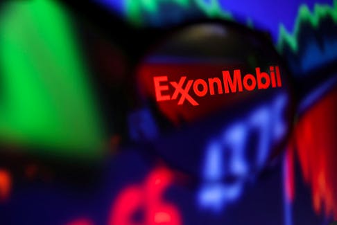 Exxon Mobil logo and stock graph are seen through a magnifier displayed in this illustration taken September 4, 2022.