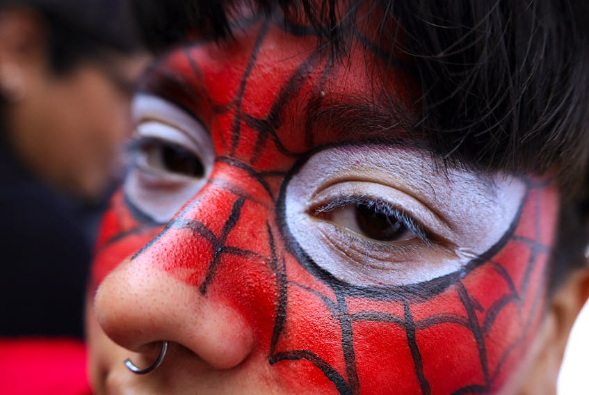 A woman dressed as Spider-Man poses for a picture at a Spider-Man cosplayers' gathering, organised in an attempt to set a Guinness World Record for the largest gathering of people dressed as Spider-Man, in Buenos Aires, Argentina October 29, 2023.