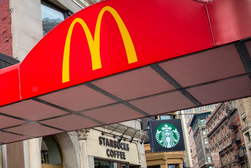 McDonald's Golden Arches are seen next to a Starbucks at the Union Square location in New York January 29, 2015.