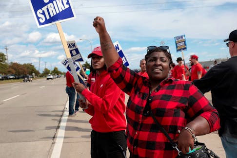 Striking United Auto Workers member Candis Holmes pickets outside the Ford Michigan Assembly Plant in Wayne, Michigan U.S., September 19, 2023.