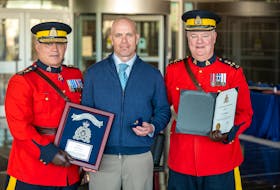 Cape Breton firefighter Scott Buchanan centre, with RCMP Commissioner Mike Duheme, left  and Assistant Commissioner Dennis Daley at the Commissioner's Commendation Awards in Dartmouth. CONTRiBUTED