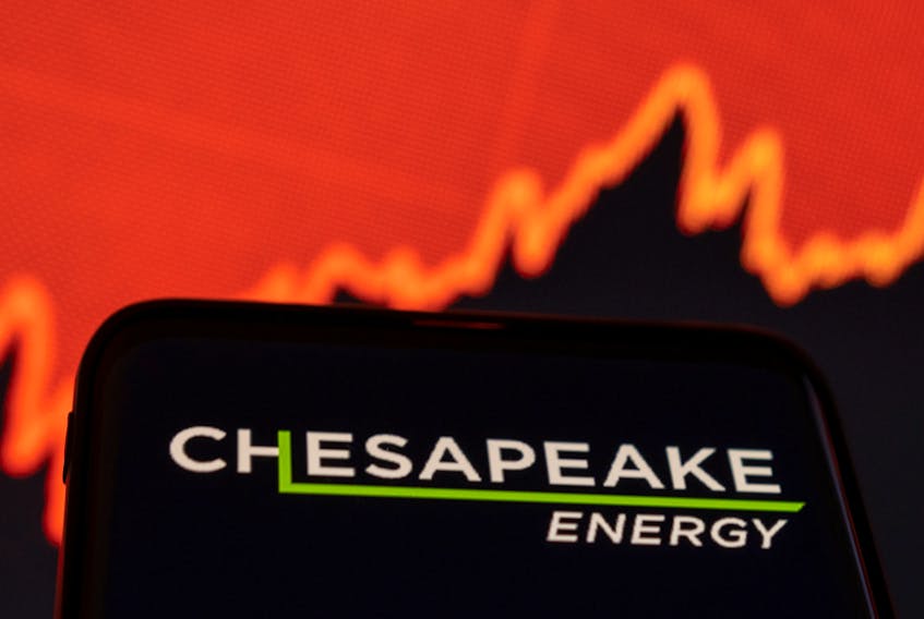 Chesapeake Energy logo is seen on smartphone in front of displayed stock graph in this illustration taken January 25, 2022.