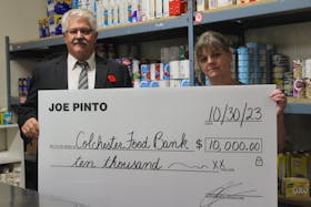 Joe Pinto, left, donates $10,000 to the Colchester Food Bank to kick-off their Food Fight fundraiser, encouraging businesses and individuals to donate money or food to help out during the holiday season. Accepting the check is Shelly DeViller, executive director of the food bank. Brendyn Creamer