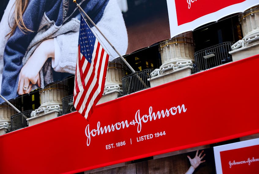 The U.S. flag is seen over the company logo for Johnson & Johnson to celebrate the 75th anniversary of the company's listing at the New York Stock Exchange (NYSE) in New York, U.S., September 17, 2019.