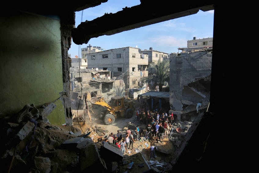 Palestinians conduct search and rescue works at the site of an Israeli strike on a house in Rafah in the southern Gaza Strip, October 30, 2023.