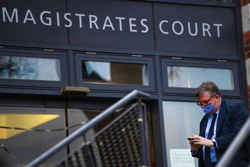 Hedge fund manager Crispin Odey uses his phone outside of Hendon Magistrates' Court whilst facing one charge of indecent assault, in Hendon, London, Britain February 17, 2021.