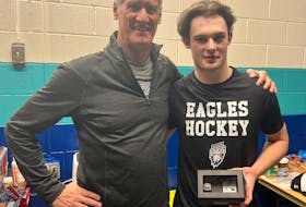 Cape Breton Eagles forward Cam MacDonald, right, is shown with Saint John Sea Dogs owner Scott McCain, who presented the 20-year-old with a new Memorial Cup ring after his was lost in the Nova Scotia wildfires last spring. CONTRIBUTED/SAINT JOHN SEA DOGS