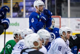 Elias Pettersson listens during the opening day of training camp in Victoria in September.