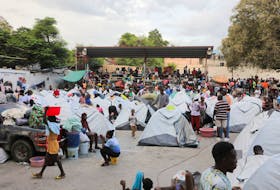 By Steven Aristil PORT-AU-PRINCE (Reuters) - "We are obliged to accept it," said Charles Adison in one of the many schools that have been converted into makeshift refugee camps in Haiti's capital