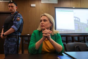 MOSCOW (Reuters) - A Russian court sentenced former state TV journalist Marina Ovsyannikova, who burst into a news broadcast with a placard that read "Stop the war" and "They're lying to you", to