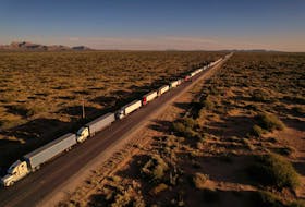 By Jose Luis Gonzalez and Brendan O'Boyle MEXICO CITY (Reuters) - Trucks attempting to enter the United States from Mexico queued for miles on Wednesday amid delays related to record migration at the