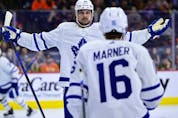 Maple Leafs' Auston Matthews (left) celebrates with teammate Mitch Marner after scoring past Philadelphia Flyers goaltender Carter Hart during a game on Saturday, April 2, 2022, in Philadelphia. 