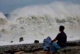 TAITUNG, Taiwan (Reuters) - Typhoon Koinu began brushing past the rural far southern tip of Taiwan on Thursday, bringing lashing rains and strong winds as a swathe of cities across the island
