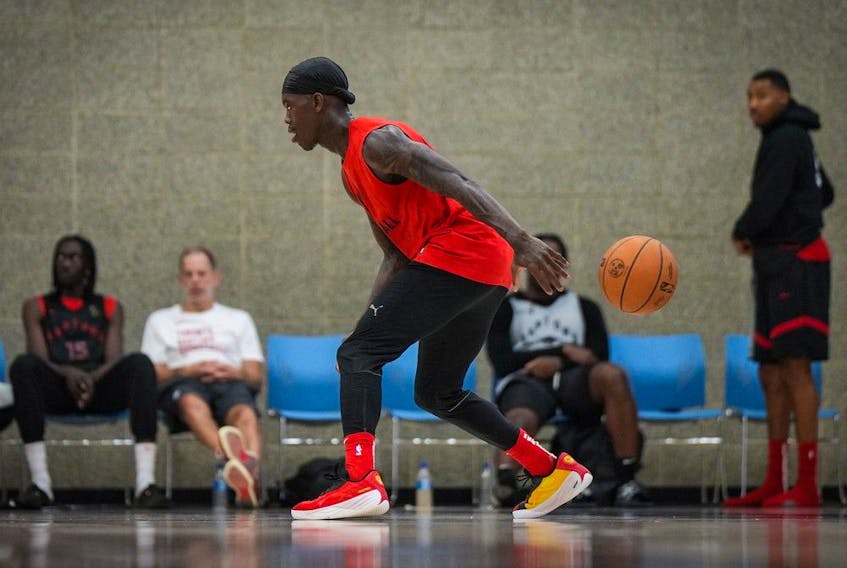 The ball slips out of Toronto Raptors point guard Dennis Schroder's hands as he shoots around during the opening day of the NBA basketball team's training camp, in Burnaby, B.C., on Tuesday October 3, 2023.