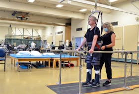 Barry Pettipas, with assistance from QEII physiotherapist Carolyn Cowan, used the body weight support system to help him learn how to walk again. Funded through a QEII Foundation Rehab Endowment Grant, the body weight support system is one example of how donors are changing the lives of QEII patients every day. PHOTO CREDIT: QEII Foundation