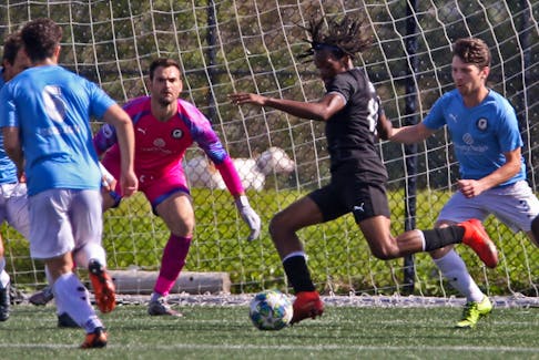 Western Halifax keeper Ben Ur, second from left, watches a moving West Ottawa Warriors' Javane Henry during action at Soccer Canada's men's senior Challenge Trophy title game at the Mainland North Commons on Monday. West Ottawa won the title 1-0.