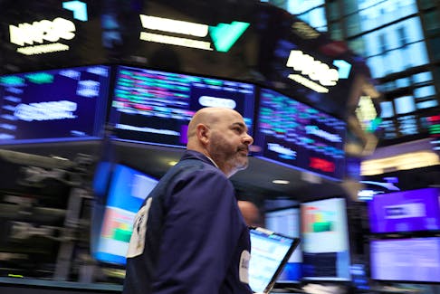 A trader works on the floor at the New York Stock Exchange (NYSE) in New York City, U.S., October 27, 2023. 