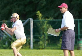Coach Mike Tanner, right, instructs players at a 2007 Citadel Phoenix football practice at the Wanderers Grounds.