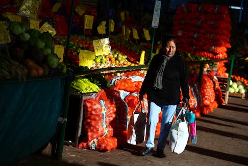 A woman walks at the Mercado Central, the city's largest wholesale central market, which receives produce from the entire country, as Argentines face a daily race for deals as inflation soars above 100%, on the outskirts of Buenos Aires, Argentina September 12, 2023.