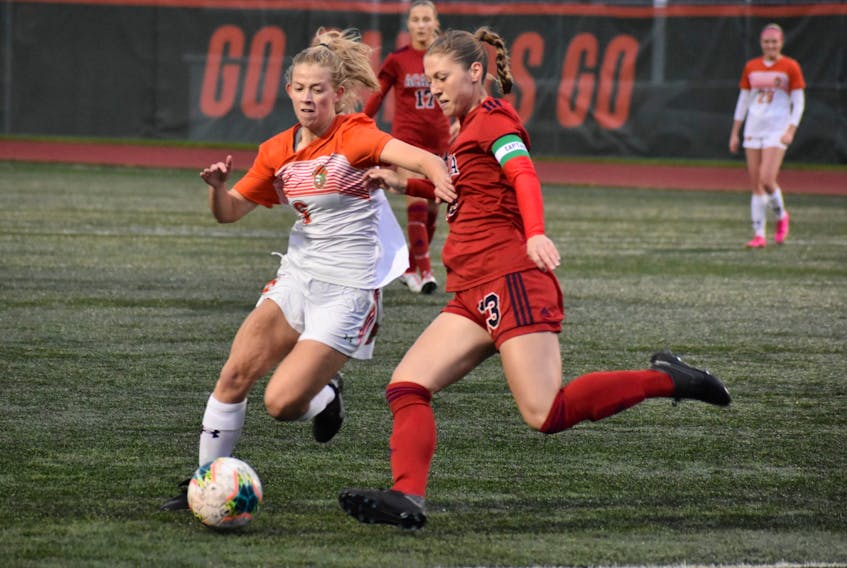Grace Hannaford of the Cape Breton Capers, left, battles for the ball with Leah Adams of the Acadia Axewomen during Atlantic University Sport women's soccer semifinal action at Ness Timmons Field in Sydney last month. Hannaford was named a U Sports Second Team All-Canadian on Wednesday night. JEREMY FRASER/CAPE BRETON POST