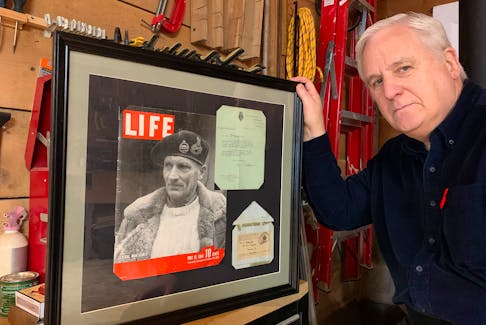 Don Sedgwick holds a framed copy of a Life Magazine cover featuring a photo of Field Marshall Bernard Law Montgomery looking pensively off to his right, as if contemplating his upcoming role as ground commander in the Normandy Invasion, and wearing a sweater that Don's grandmother, Jessica Miriam Sedgwick, knitted. - John DeMont