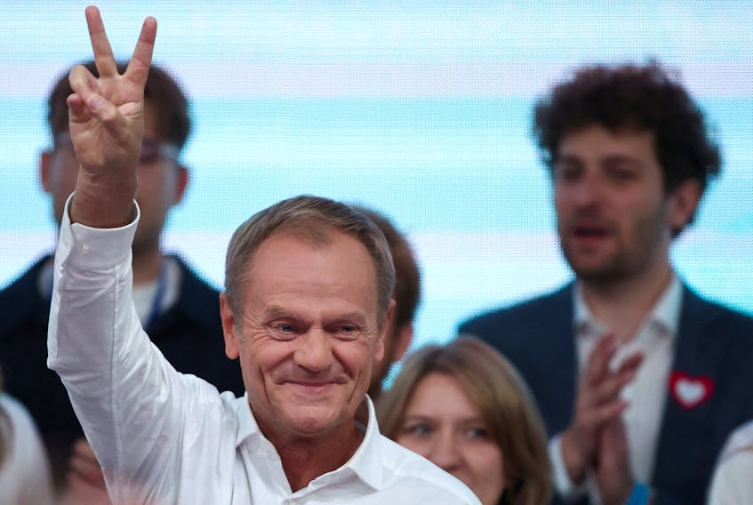 Donald Tusk, leader of the largest opposition grouping Civic Coalition (KO), gestures after the exit poll results are announced in Warsaw, Poland, October 15, 2023.
