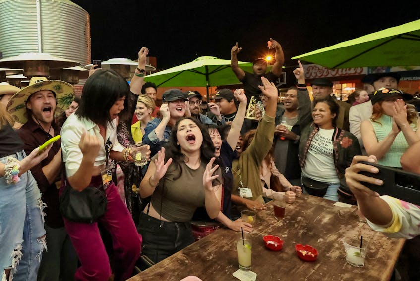 People celebrate after the SAG-AFTRA TV/Theatrical Committee approved a tentative agreement with the Alliance of Motion Picture and Television Producers (AMPTP) to bring an end to the 118-day actors strike, at a brewery in Los Angeles, California,. U.S. November 8, 2023. 