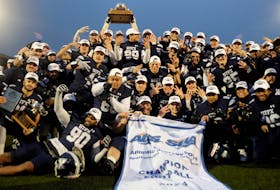 The St. Francis Xavier X-Men celebrate their Loney Bowl conference championship victory Saturday afternoon in Antigonish. St. F.X. defeated the Bishop's Gaiters 34-23 for its third straight AUS football title. - Bryan Kennedy / St. F.X. Athletics