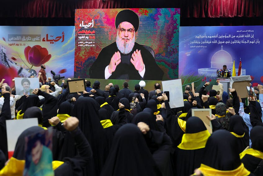 Lebanon's Hezbollah leader Sayyed Hassan Nasrallah addresses his supporters through a screen during a rally commemorating the annual Hezbollah Martyrs' Day, in Beirut's southern suburbs, Lebanon November 11, 2023.