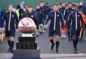 Soccer officials lead the Montreal Carabins, left, and Cape Breton Capers, right, onto the field as the Sam Davidson Memorial Trophy appears in front of them prior to the U Sports Men’s Soccer Championship final at Ness Timmons Field in Sydney on Sunday. Cape Breton won the game 1-0. JEREMY FRASER/CAPE BRETON POST.
