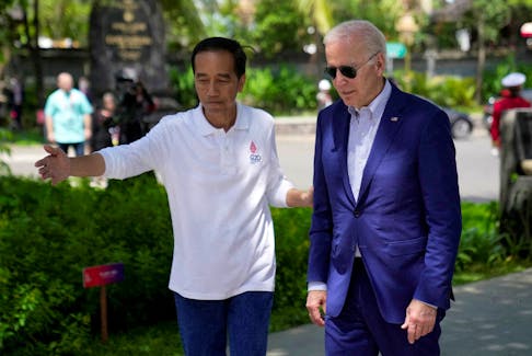 Indonesian President Joko Widodo greets U.S. President Joe Biden upon his arrival for a mangrove planting event at Ngurah Rai Forest Park, on the sidelines of the G20 summit in Denpasar, Bali, Indonesia November 16, 2022. Dita Alangkara/Pool via