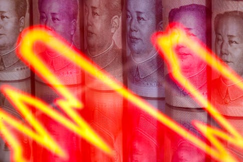 Chinese Yuan banknotes are seen behind illuminated stock graph in this illustration taken February 10, 2020.