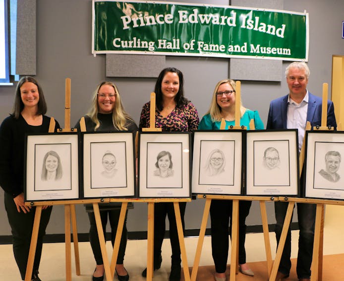 Members of the 2001 world junior women’s curling championships stand behind portraits from artist Wayne Wright during a recent P.E.I. Curling Hall of Fame and Museum induction ceremony in Cornwall. From left are skip Suzanne Gaudet (now Birt), third Stefanie Richard (now Clark), second Robyn MacPhee, lead Kelly Higgins (now Steele) and coach Paul Power. Alternate Carol Webb (now Whitaker) was unable to attend due to a curling commitment. Contributed