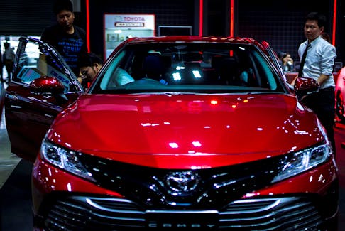 Visitors look at a Toyota Camry car during the Bangkok Auto Salon 2019 in Bangkok, Thailand, July 4, 2019. Picture taken July 4, 2019.